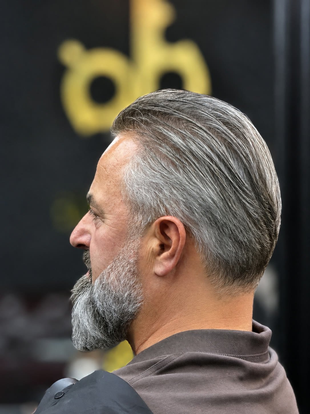Classic slicked-back cut with beard grooming